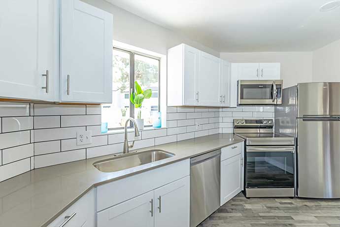 White Shaker kitchen cabinets with modern countertops